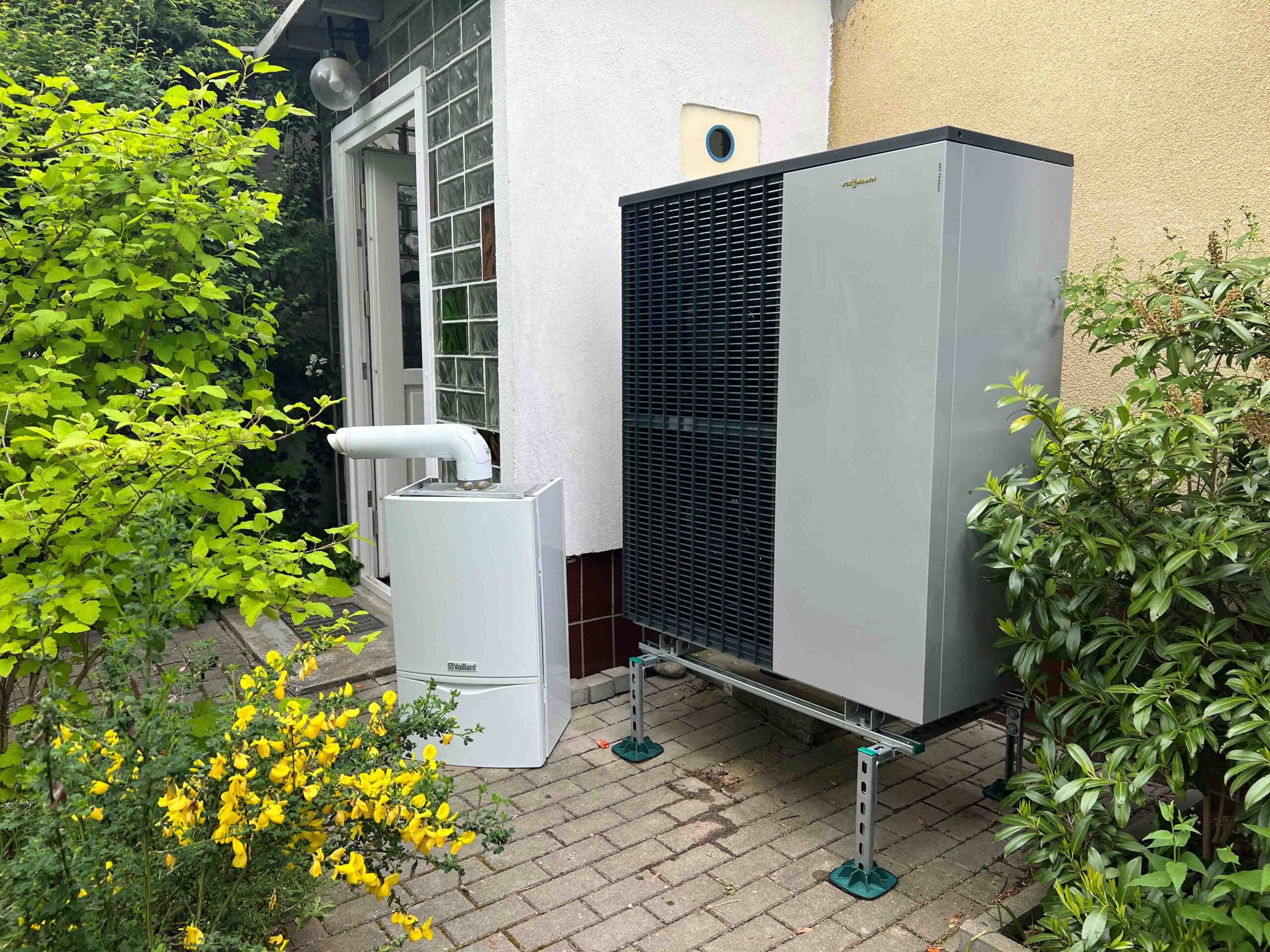 Luft-Wasser-Wärmepumpe Außengerät neben dem Hauseingang eines Berliner Einfamilienhauses